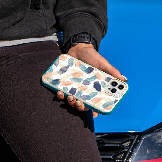 iPhone 14 Pro Pastel Brush Stroke Abstract Design Case - Fremont Grip Blue and Cream LifeStyle Shot (Girl in Black Holding Her Phone)